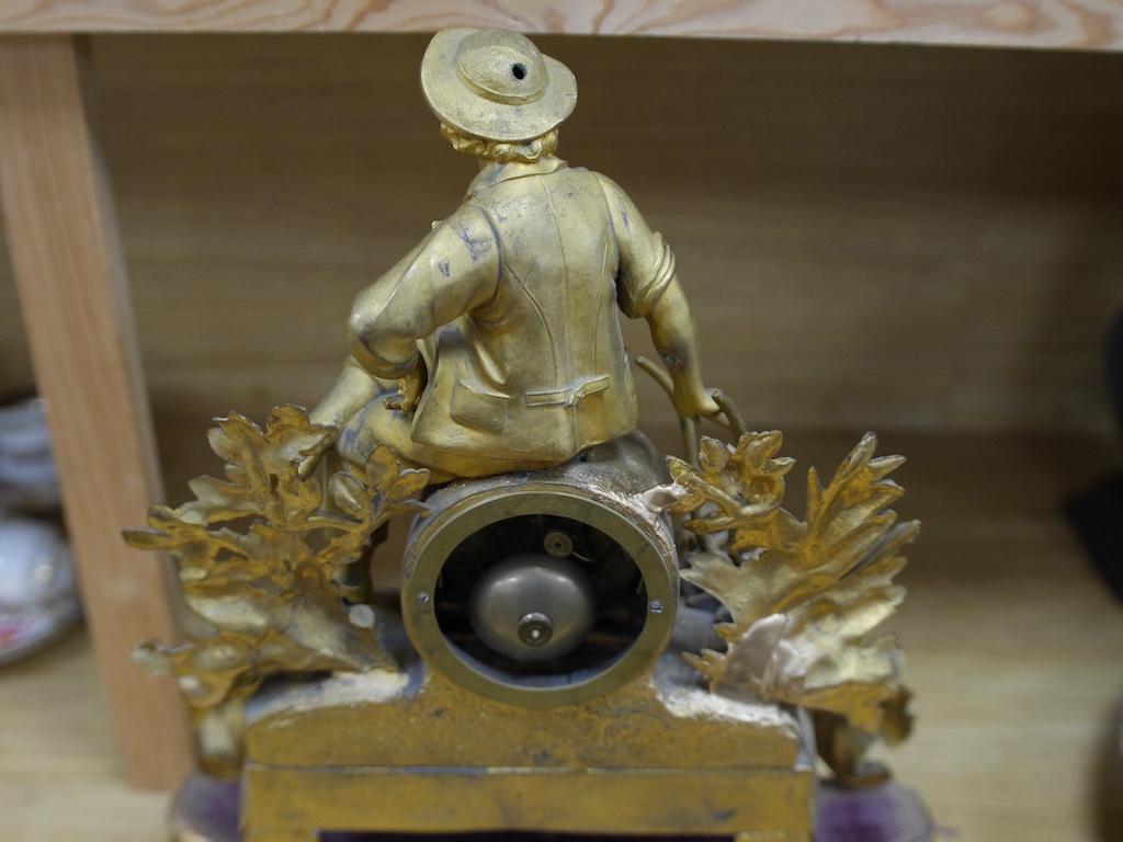 A 19th century French gilt spelter with seated youth mantel clock, with key and pendulum, 43cm. Condition - fair to good, not tested